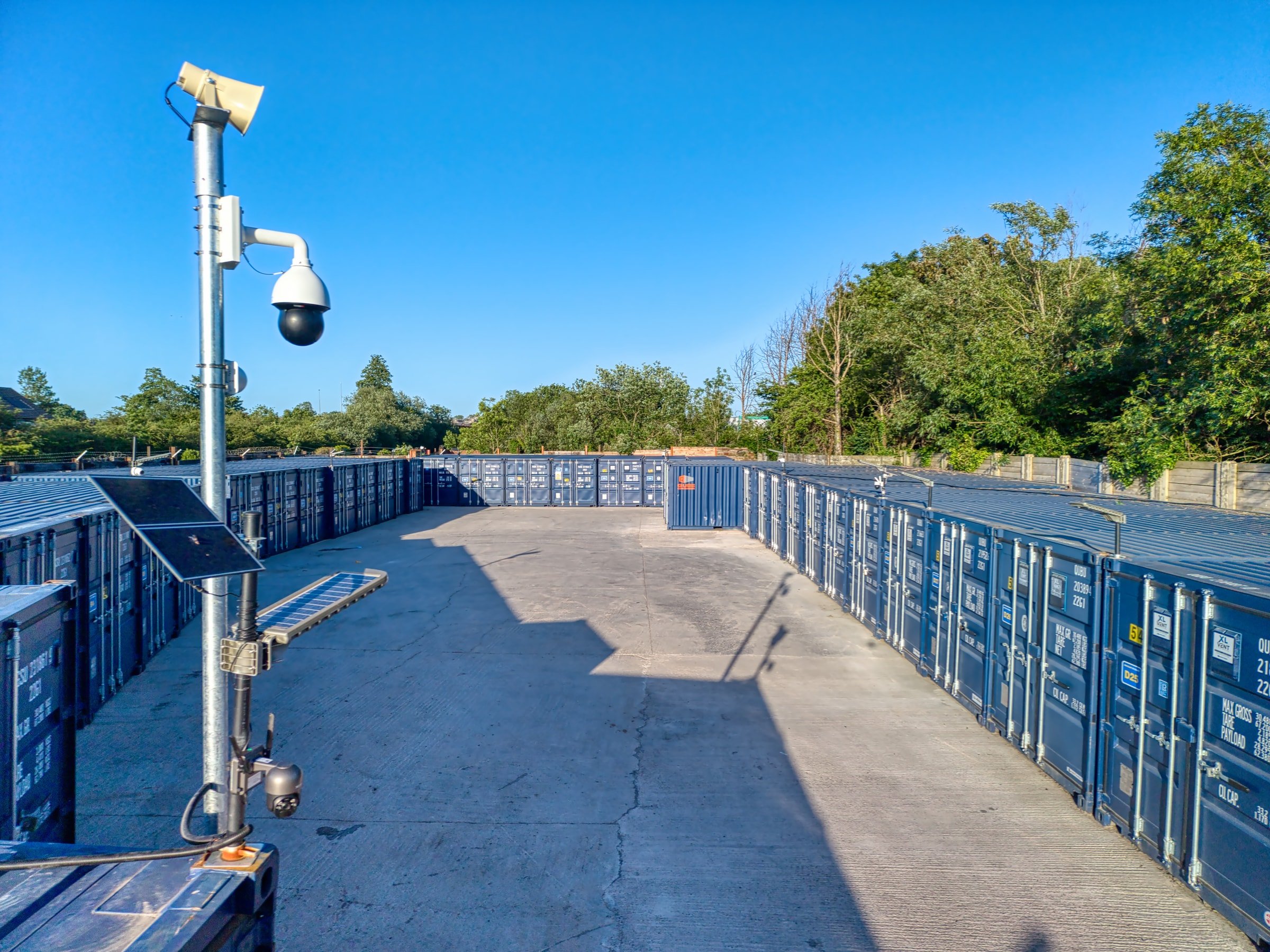 Raised security overview showing a dome CCTV camera and solar panel above the Discount Storage container yard