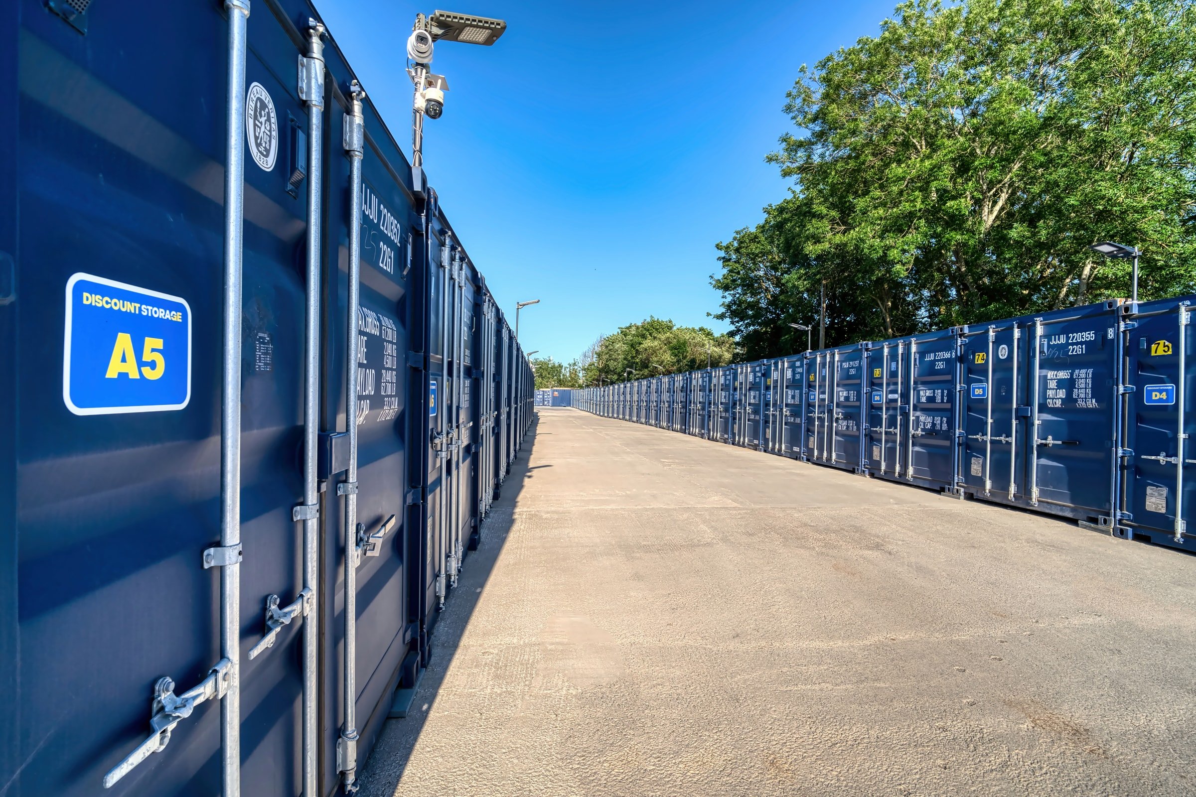 Numbered storage container with a CCTV camera on the lighting column covering the access lane